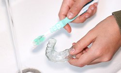 Patient in Idaho Falls cleaning their ClearCorrect aligners