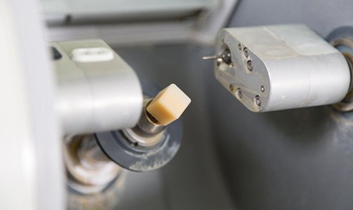 Close up of a block of porcelain in a CEREC mill