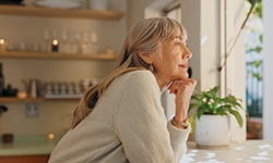 Woman looking out window in kitchen