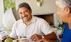 Man smiling after receiving denture