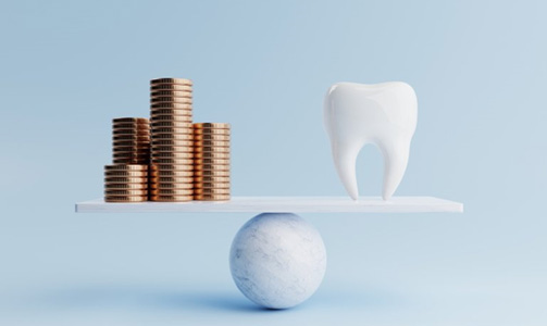 Coins and tooth balanced on a scale