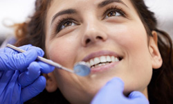 Female patient smiling for dentist during examination