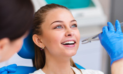 Woman holding mouth open for tooth extraction