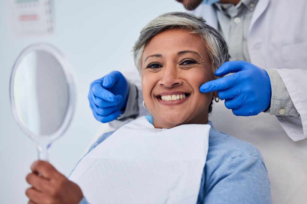 A woman smiling in a dental chair