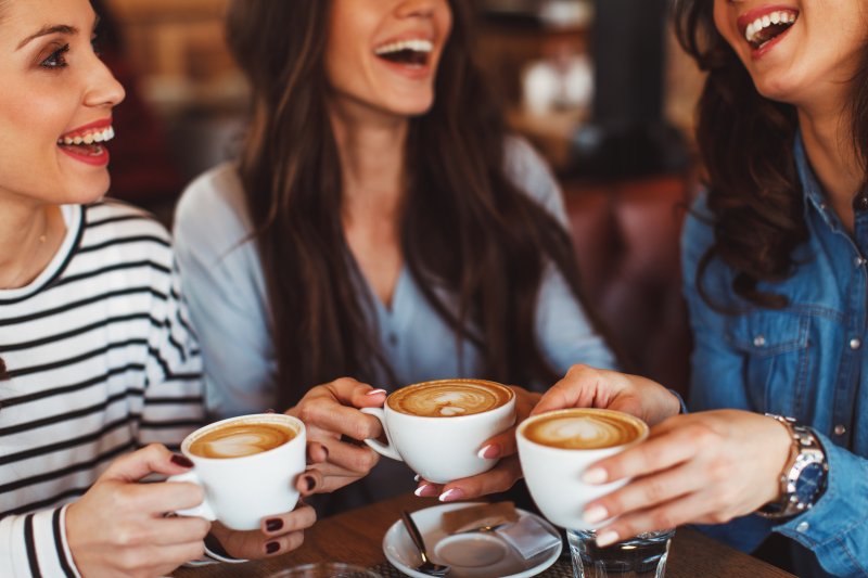 ClearCorrect patient drinking coffee with friends.