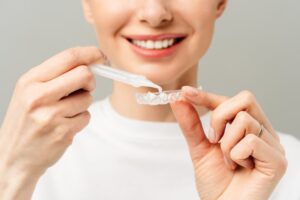 Woman using professional teeth whitening kit
